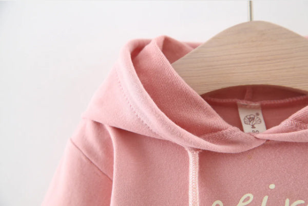 Discover the perfect mix of cozy and chic! This adorable hoodie dress features a soft cotton top with a layered tulle skirt. Perfect for playdates & outings!