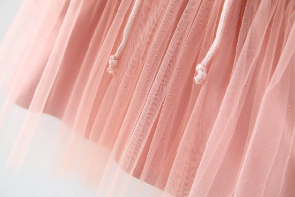 Discover the perfect mix of cozy and chic! This adorable hoodie dress features a soft cotton top with a layered tulle skirt. Perfect for playdates & outings!