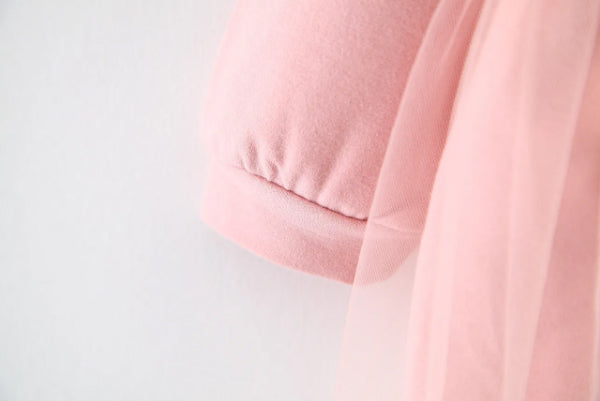 Discover the perfect mix of cozy and chic! This adorable hoodie dress features a soft cotton top with a layered tulle skirt. Perfect for playdates & outings!