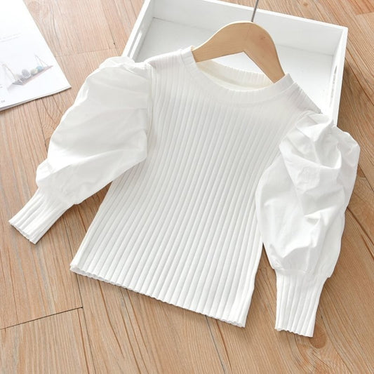 A chic and stylish puff sleeve top for girls! Made from soft, breathable cotton, this trendy top is perfect for everyday wear, playdates, or special occasions. Available in white & black.