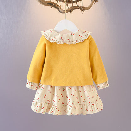 Wrap your baby girl in vintage charm with this adorable two-piece cotton set. Featuring a ruffled cardigan and cherry-print skirt, this breathable, stylish ensemble is perfect for any season!