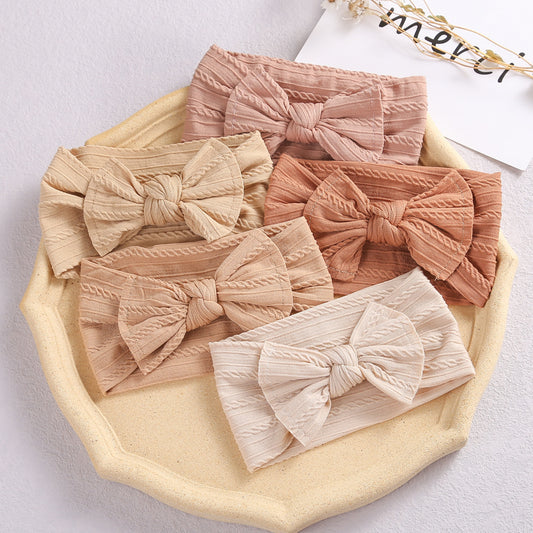 Add a stylish touch to your baby’s look with our soft, stretchy nylon bow headband. Gentle, comfortable, and perfect for everyday wear or special occasions