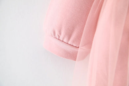 Discover the perfect mix of cozy and chic! This adorable hoodie dress features a soft cotton top with a layered tulle skirt. Perfect for playdates & outings!