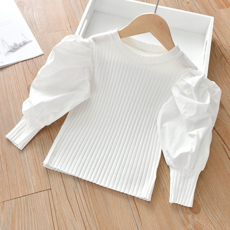 A chic and stylish puff sleeve top for girls! Made from soft, breathable cotton, this trendy top is perfect for everyday wear, playdates, or special occasions. Available in white & black.